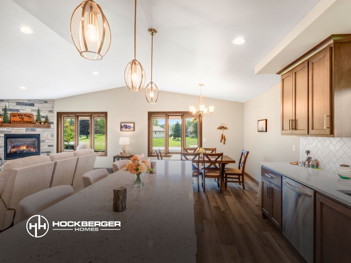 A living room with a fireplace and a dining room with a table and chairs.