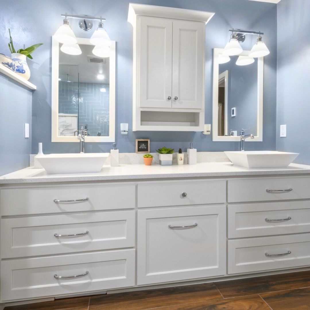A bathroom with two sinks and two mirrors