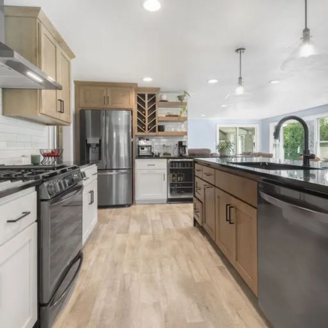 A kitchen with stainless steel appliances and wooden cabinets
