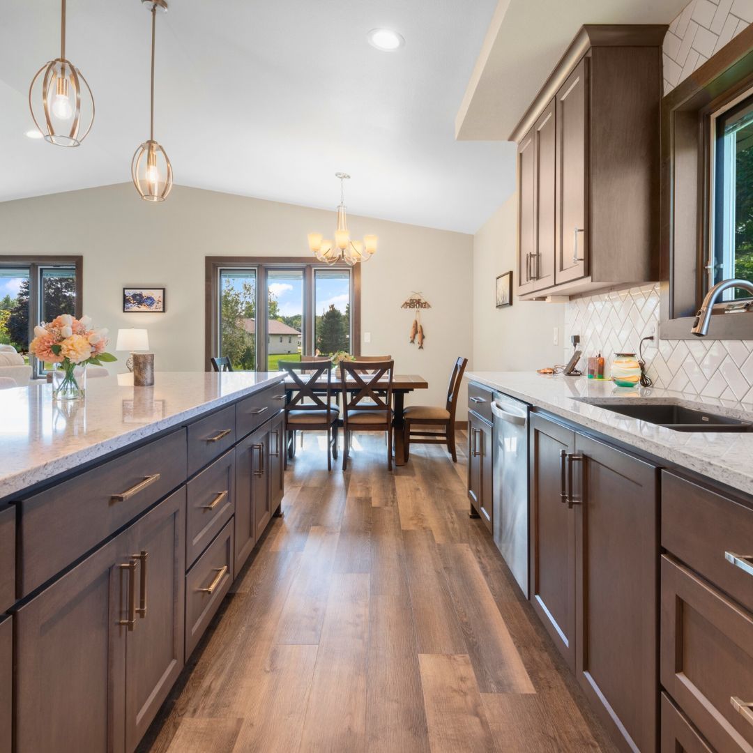 A kitchen with brown cabinets and white counter tops