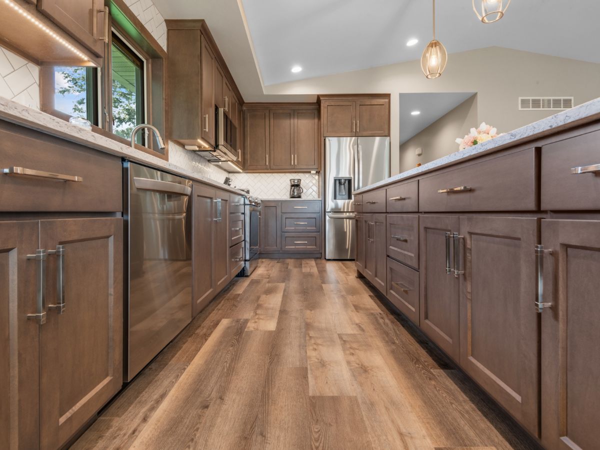A kitchen with wooden cabinets and stainless steel appliances.