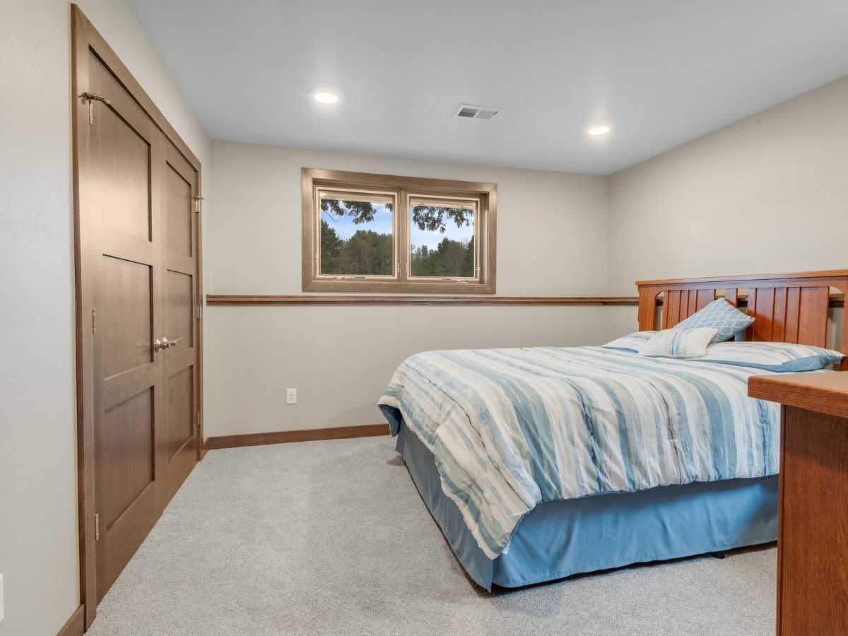 A bedroom with a large bed and a window