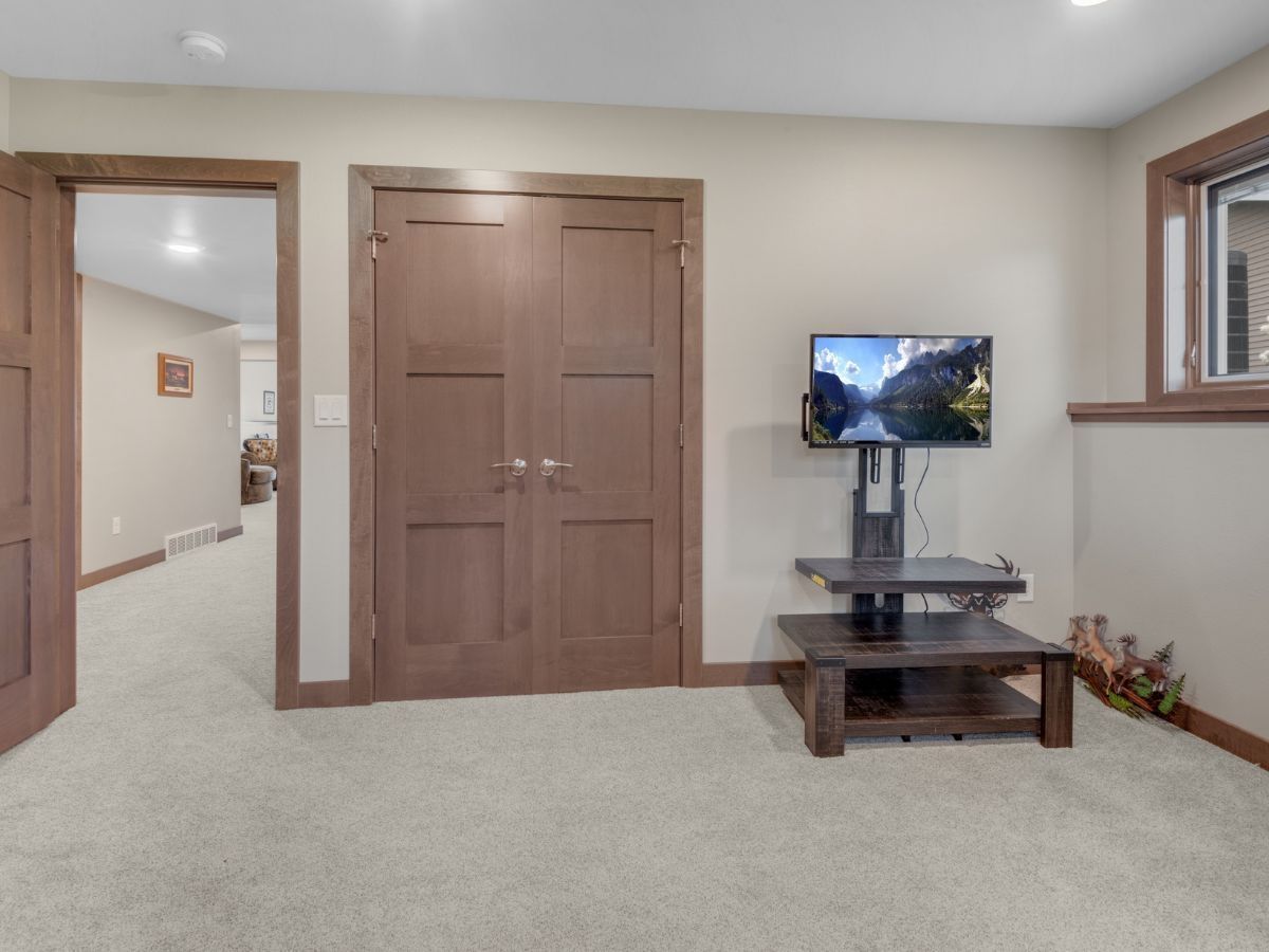 A living room with a flat screen tv on a stand