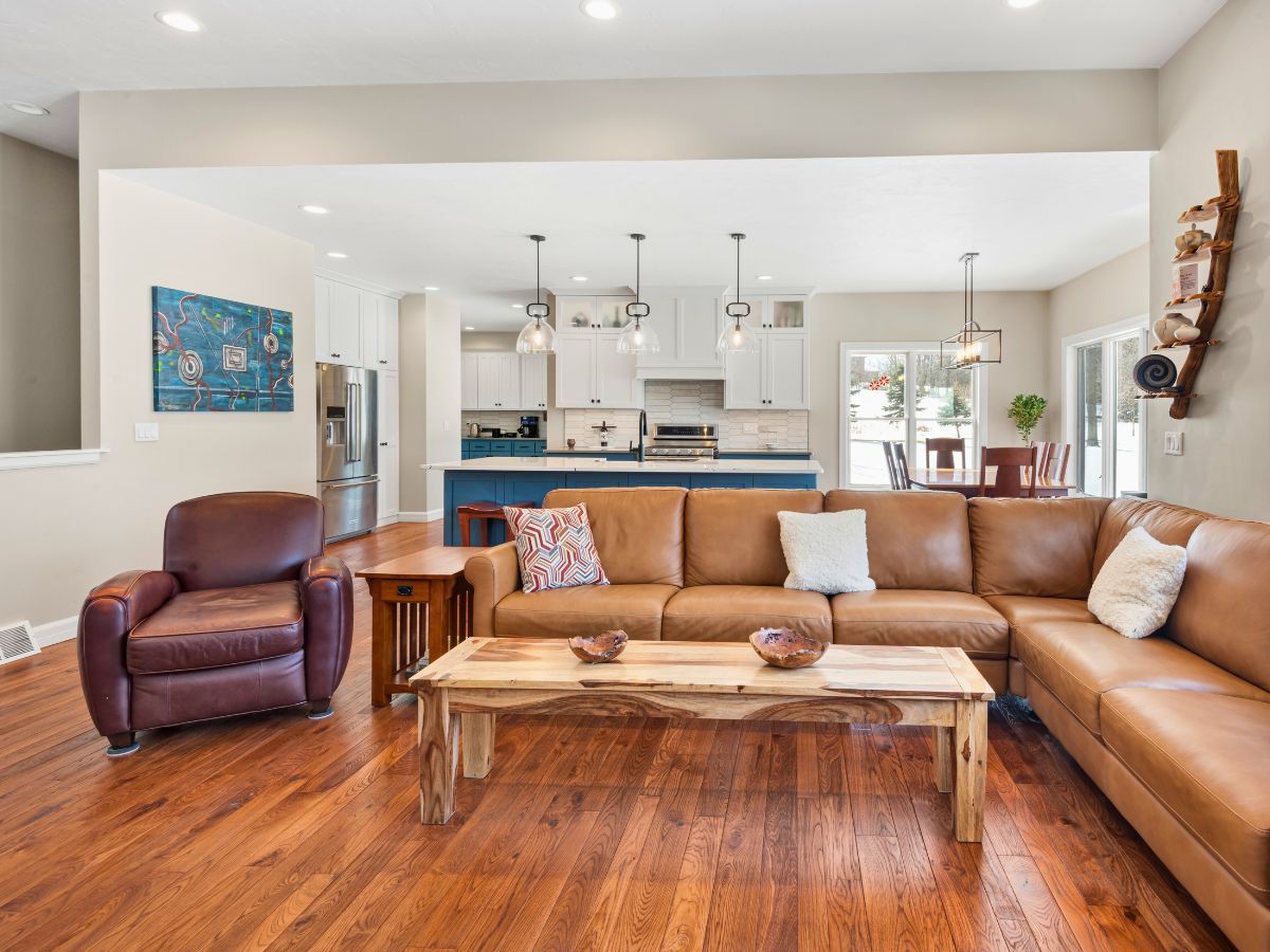A living room with a couch , chair and coffee table.