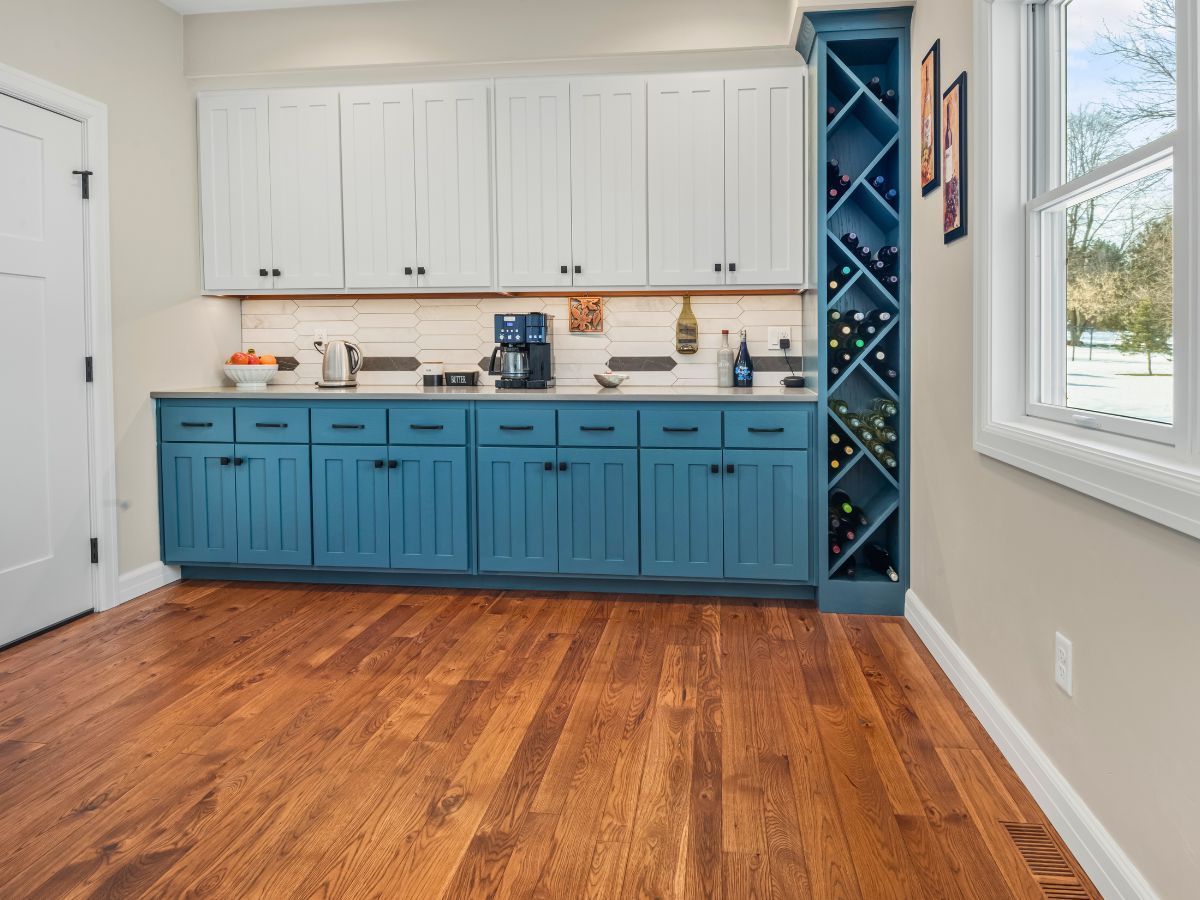 A kitchen with blue cabinets and a wine rack