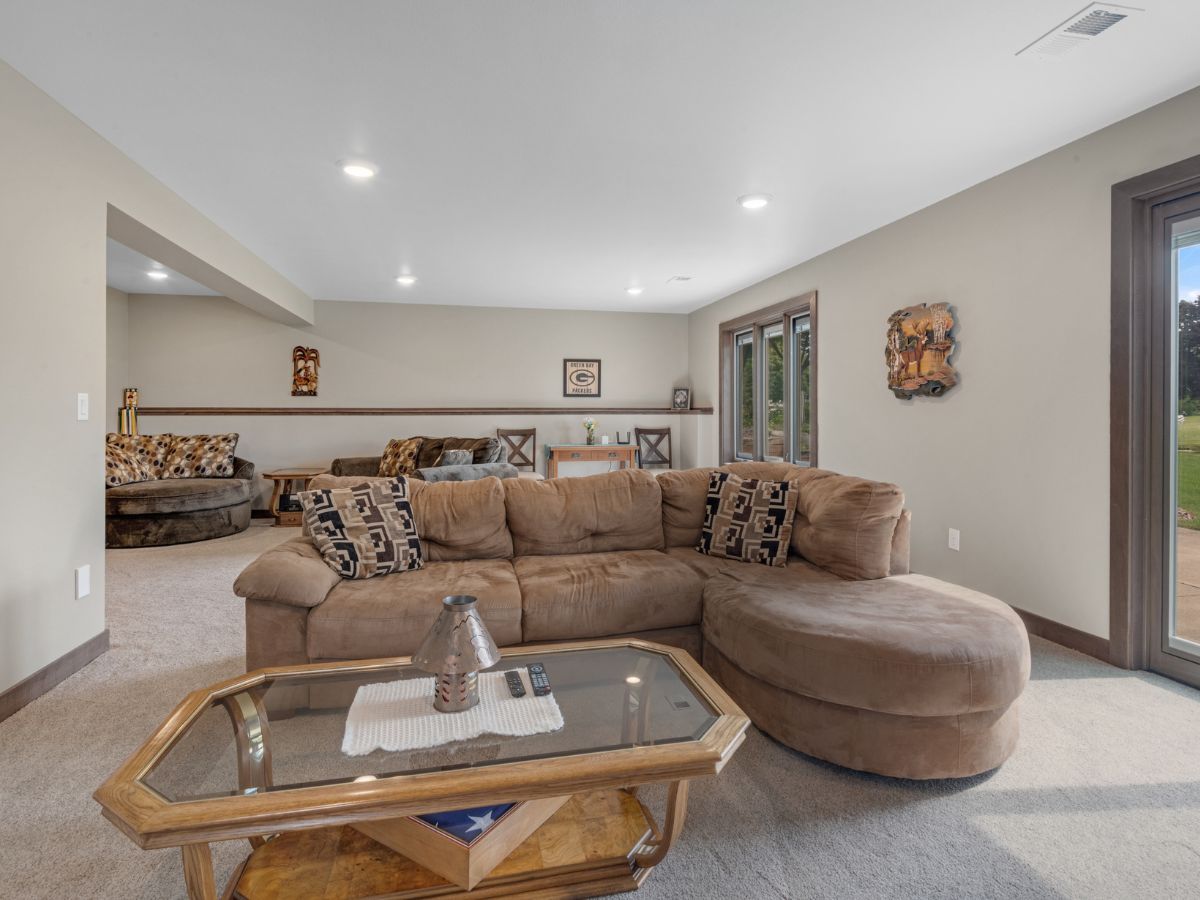 A living room with a couch , coffee table , and sliding glass doors.