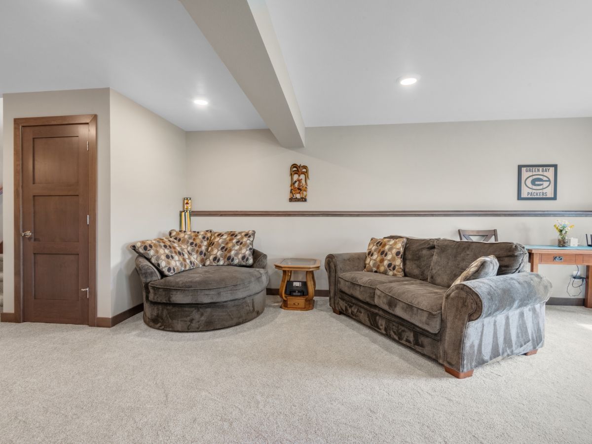 A living room with a couch , chair , and table.