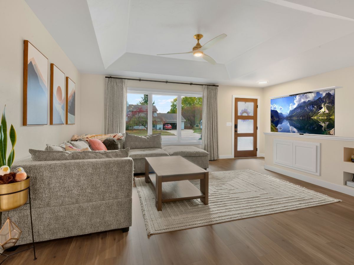 A living room with a couch , coffee table , and television.