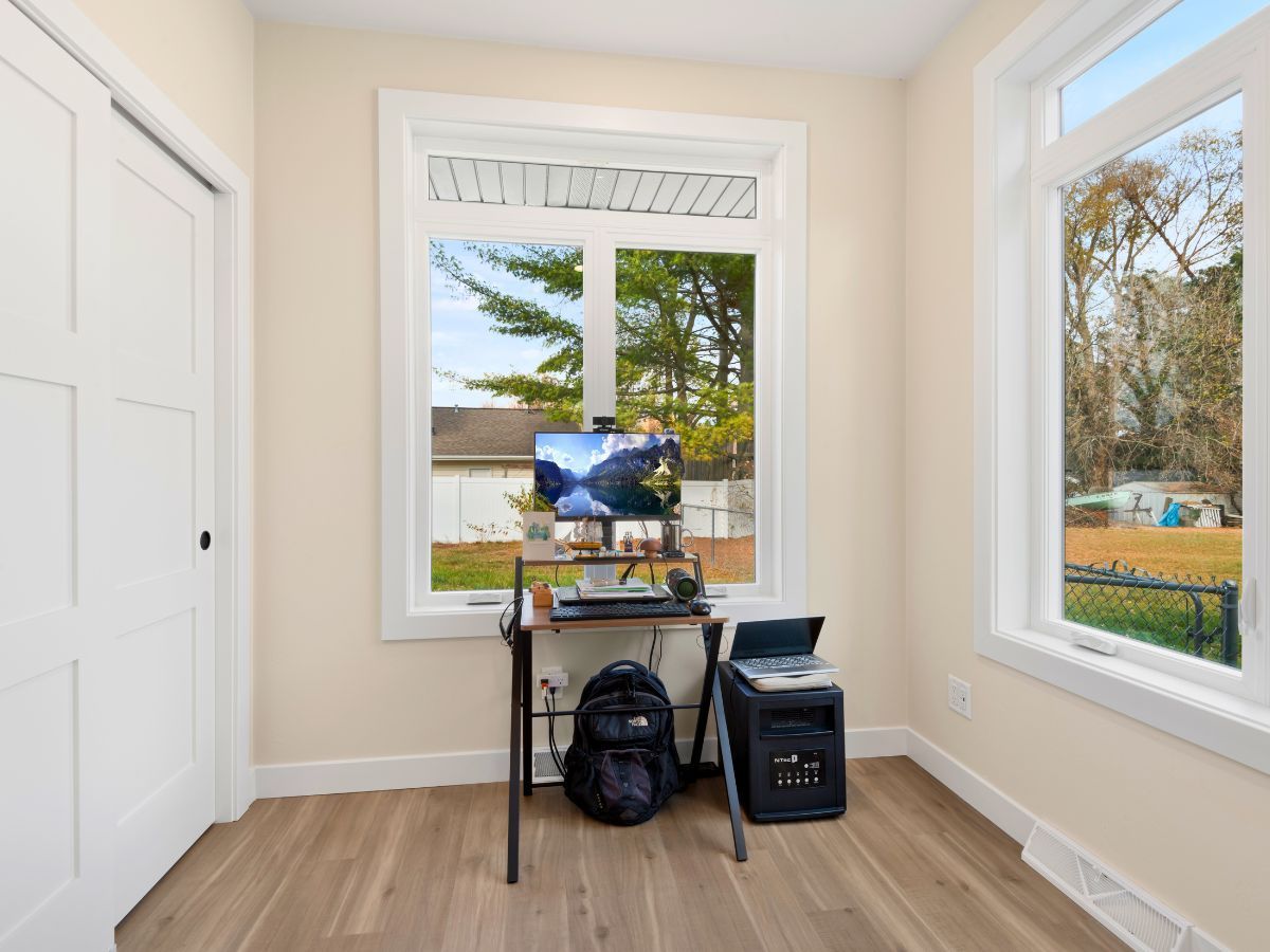 A room with a desk and a computer in it