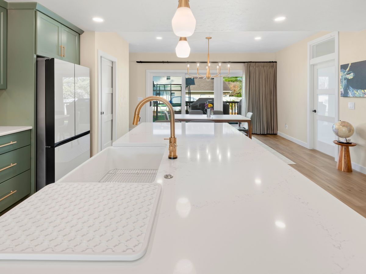 A kitchen with a sink and a refrigerator in it.