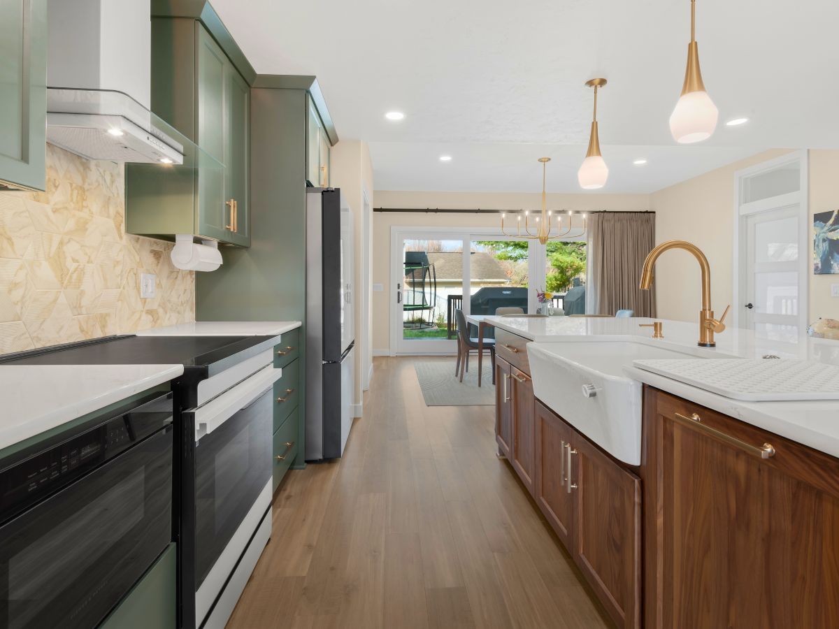 A kitchen with a stove , dishwasher , refrigerator and sink.