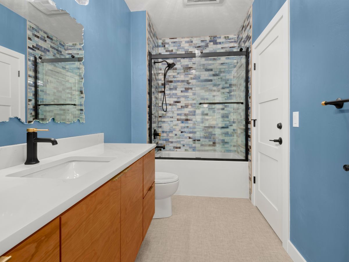 A bathroom with blue walls and a bathtub