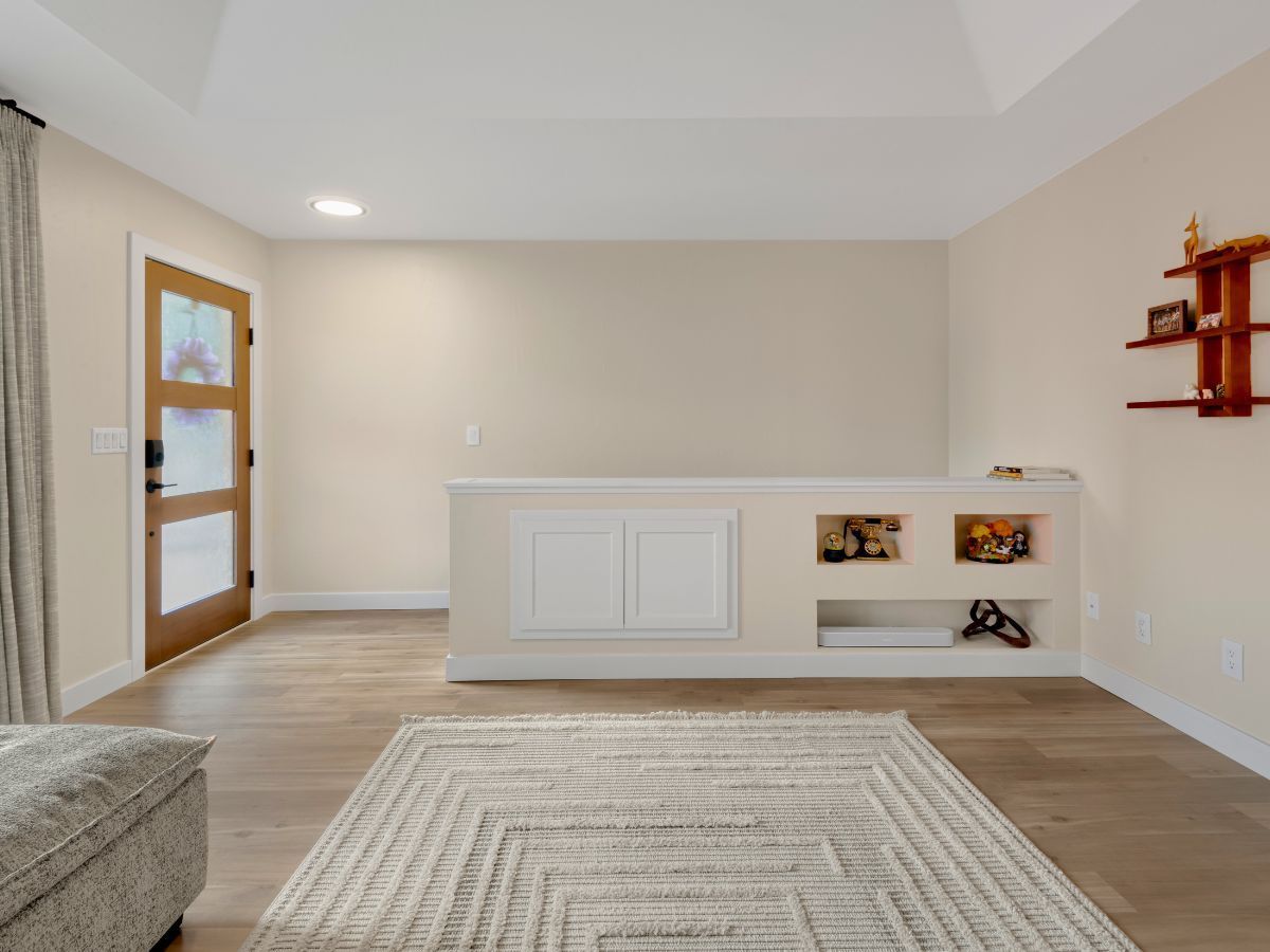 A living room with hardwood floors and a rug
