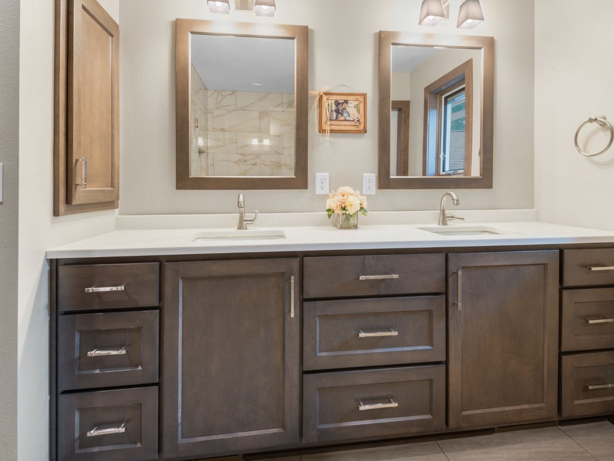 A bathroom with two sinks and two mirrors.