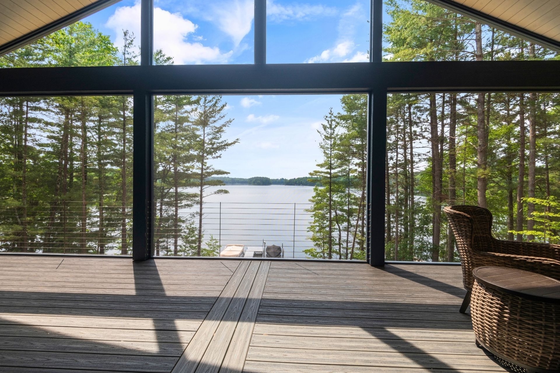 A large window with a view of a lake and trees.