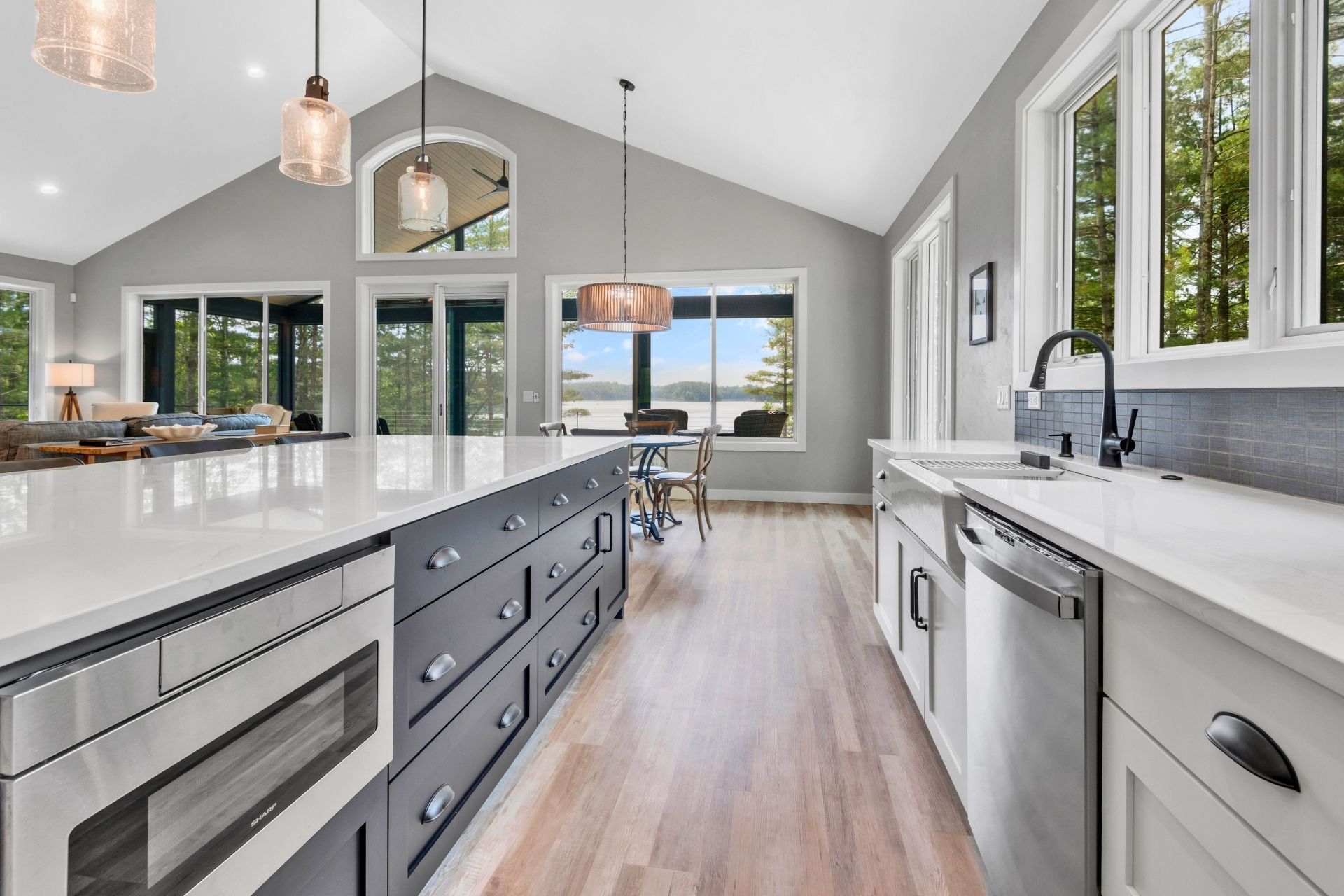 A kitchen with a large island in the middle and lots of windows.