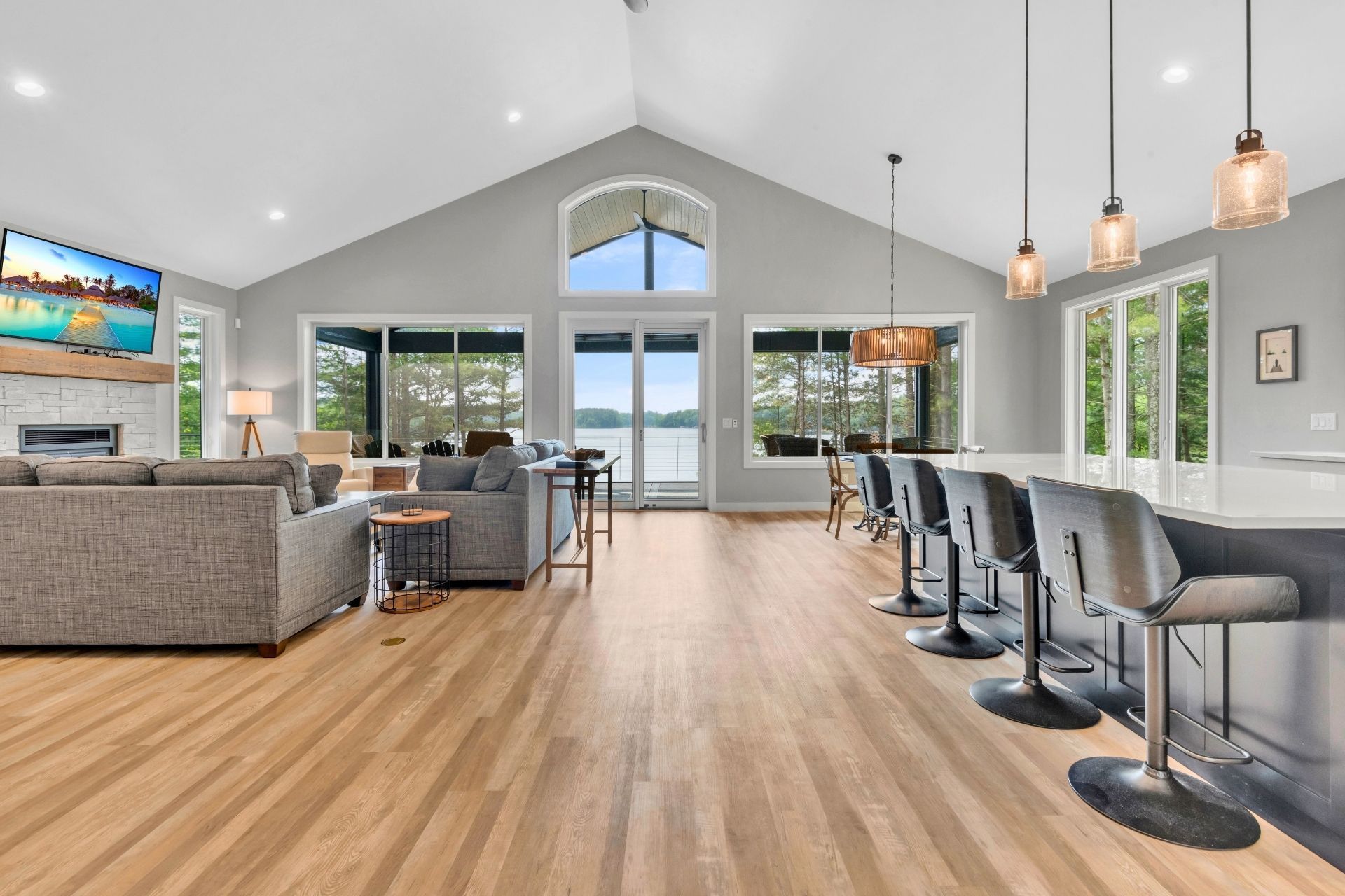 A large living room with hardwood floors and a vaulted ceiling.