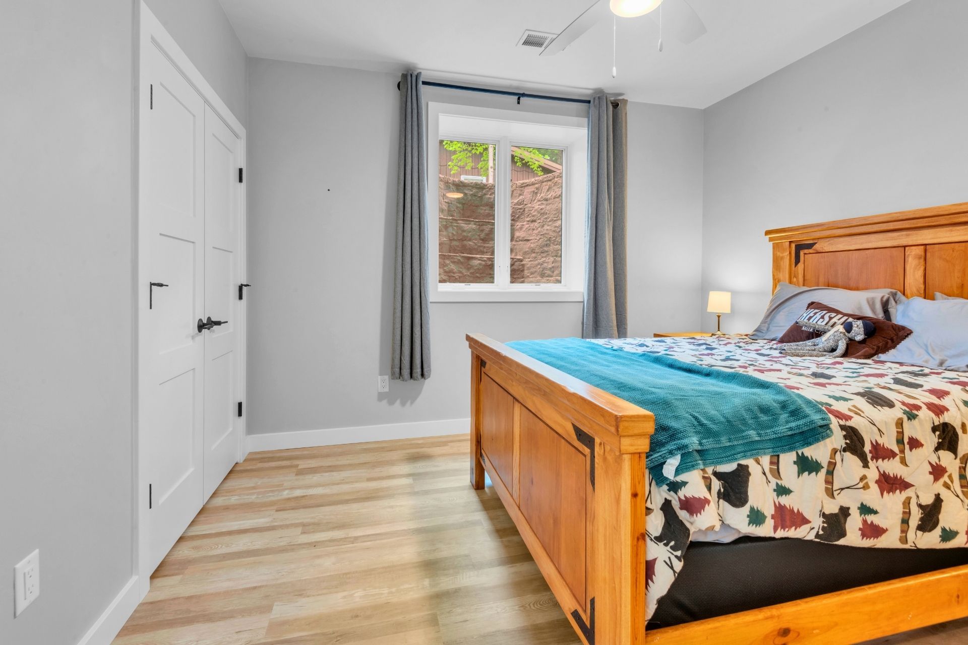 A bedroom with a king size bed and a window.