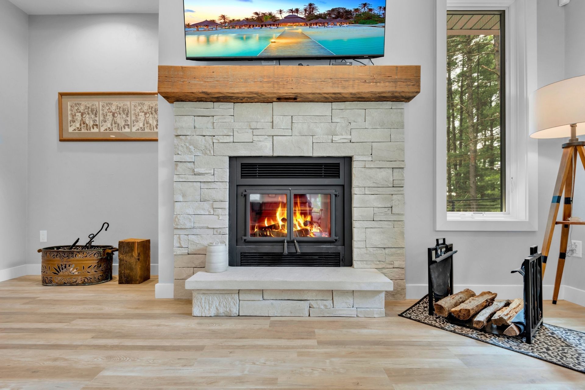 A living room with a fireplace and a flat screen tv.