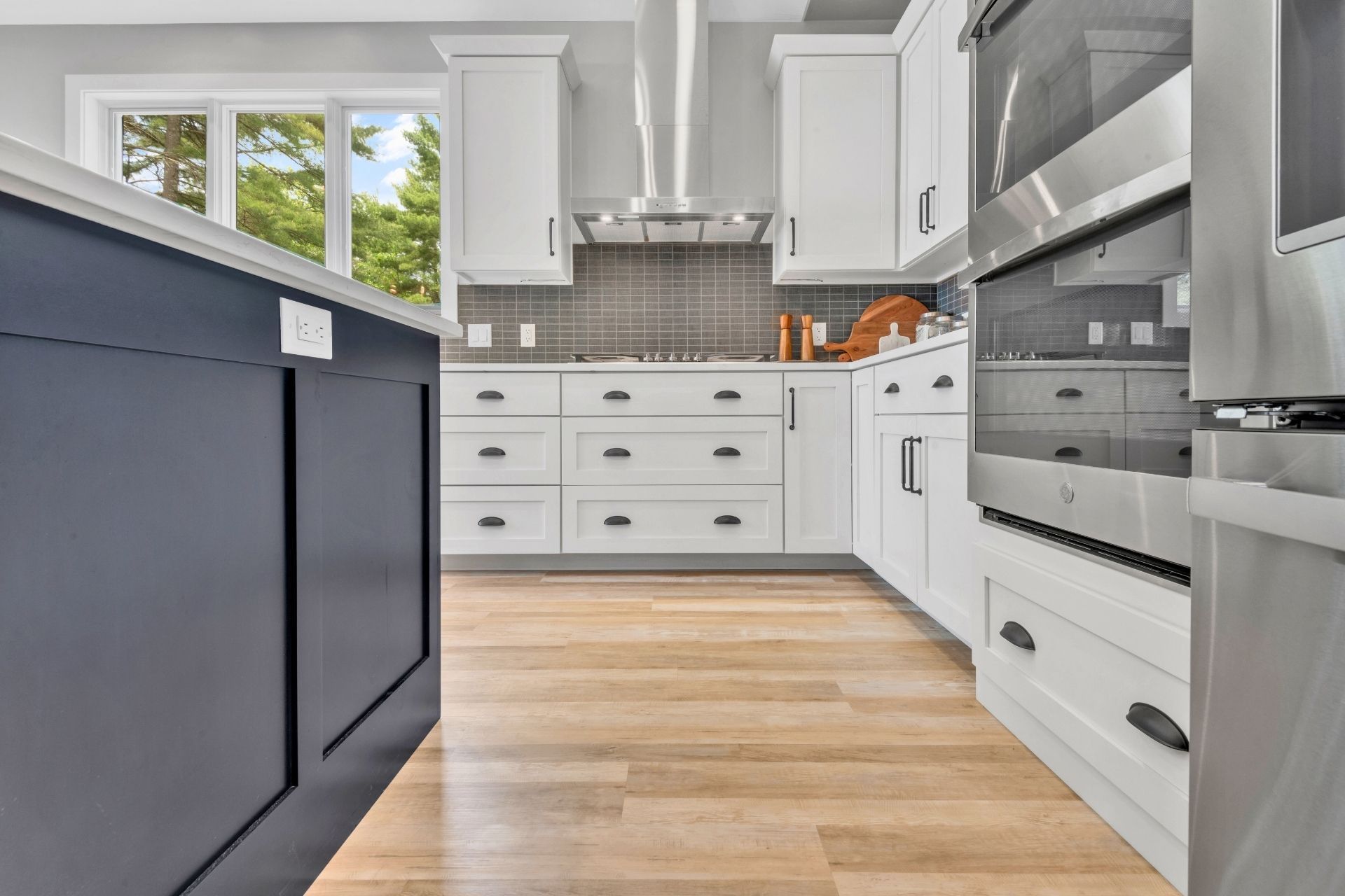 A kitchen with white cabinets and stainless steel appliances
