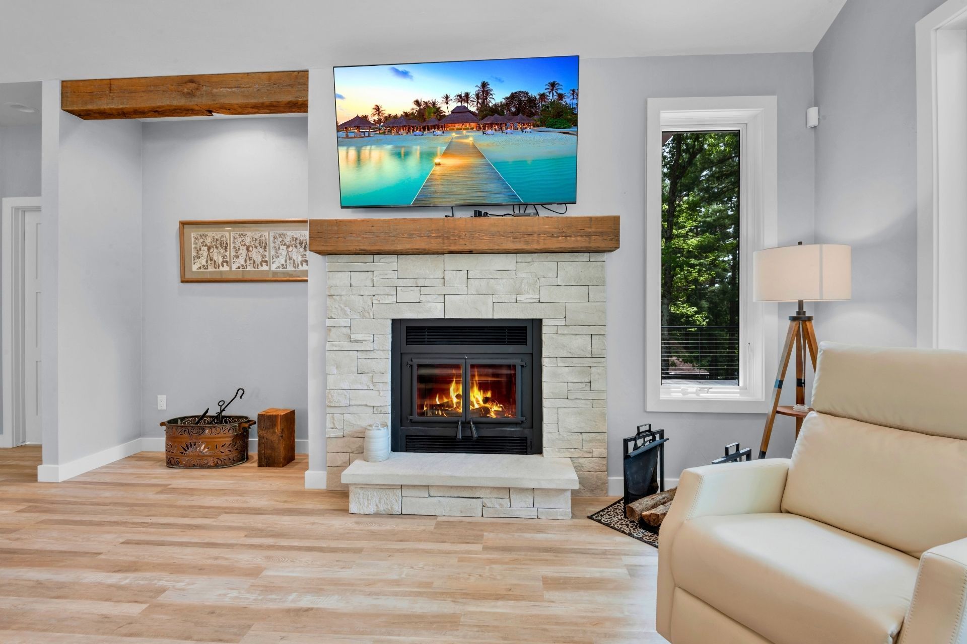 A living room with a fireplace and a flat screen tv