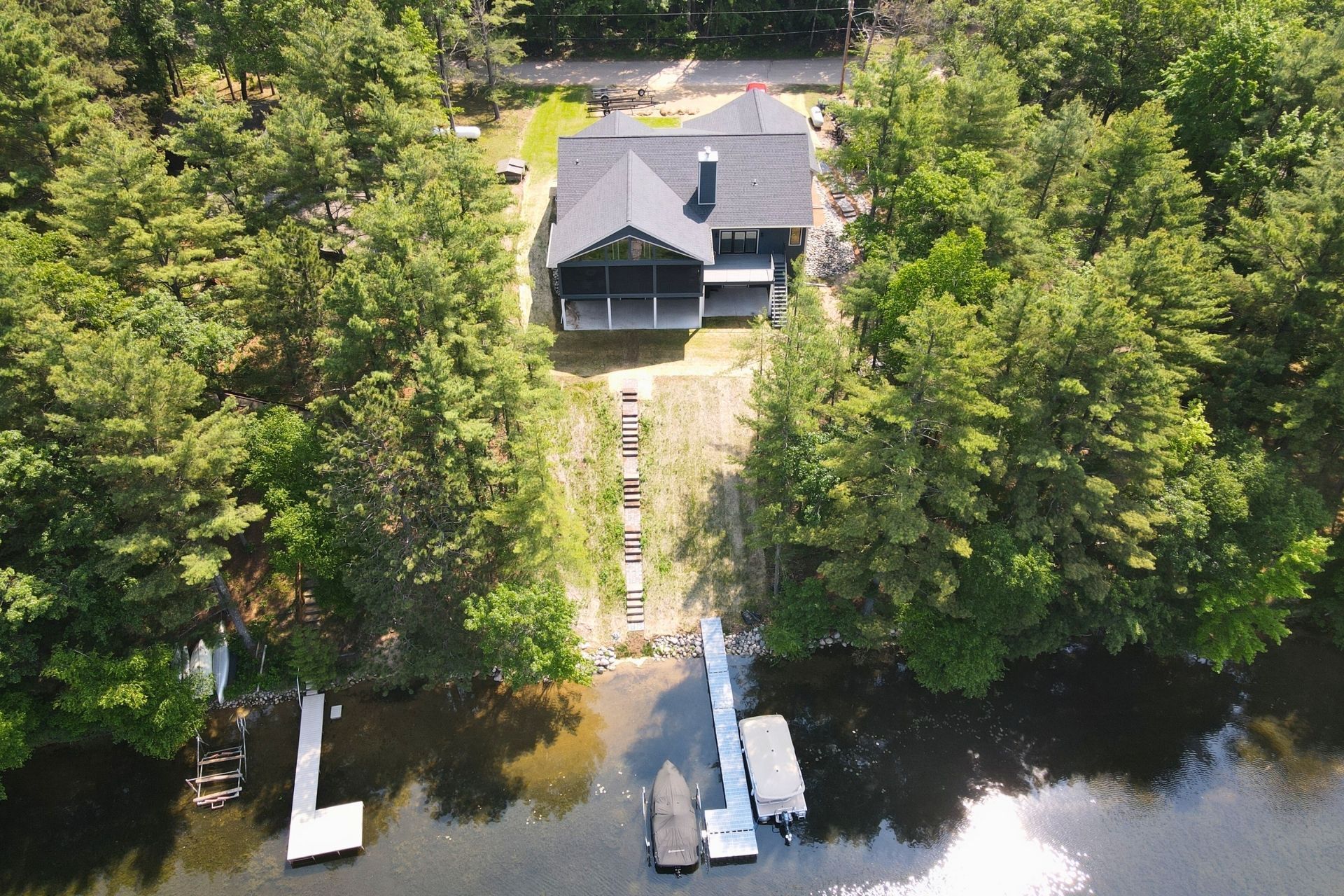 An aerial view of a house on a lake