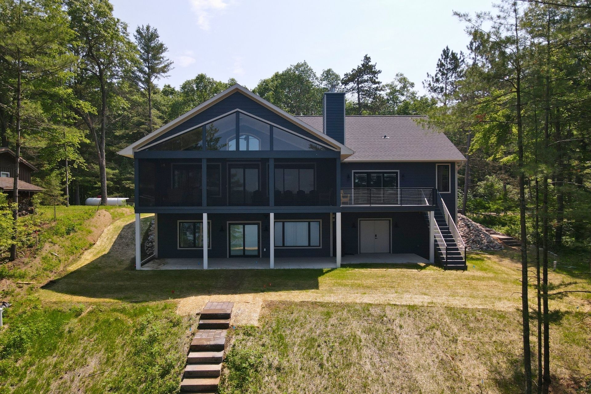 An aerial view of a large house surrounded by trees.