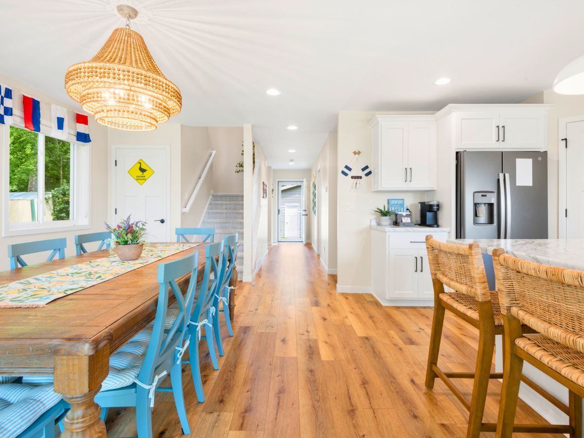 A kitchen with a table and chairs and a refrigerator.