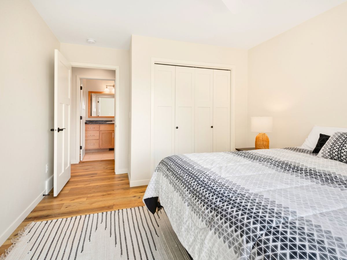 A bedroom with a king size bed and a rug.