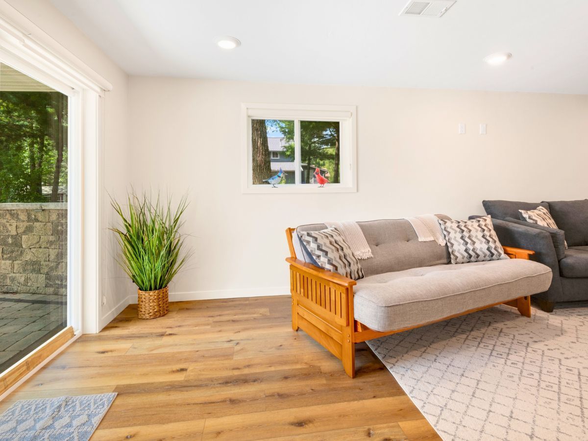 A living room with a couch and a sliding glass door.