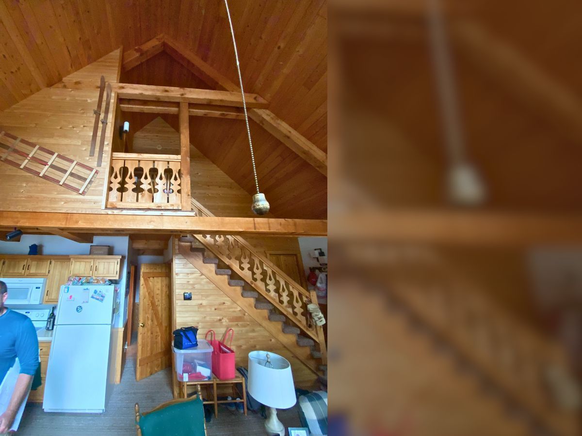 A wooden house with stairs leading up to the second floor
