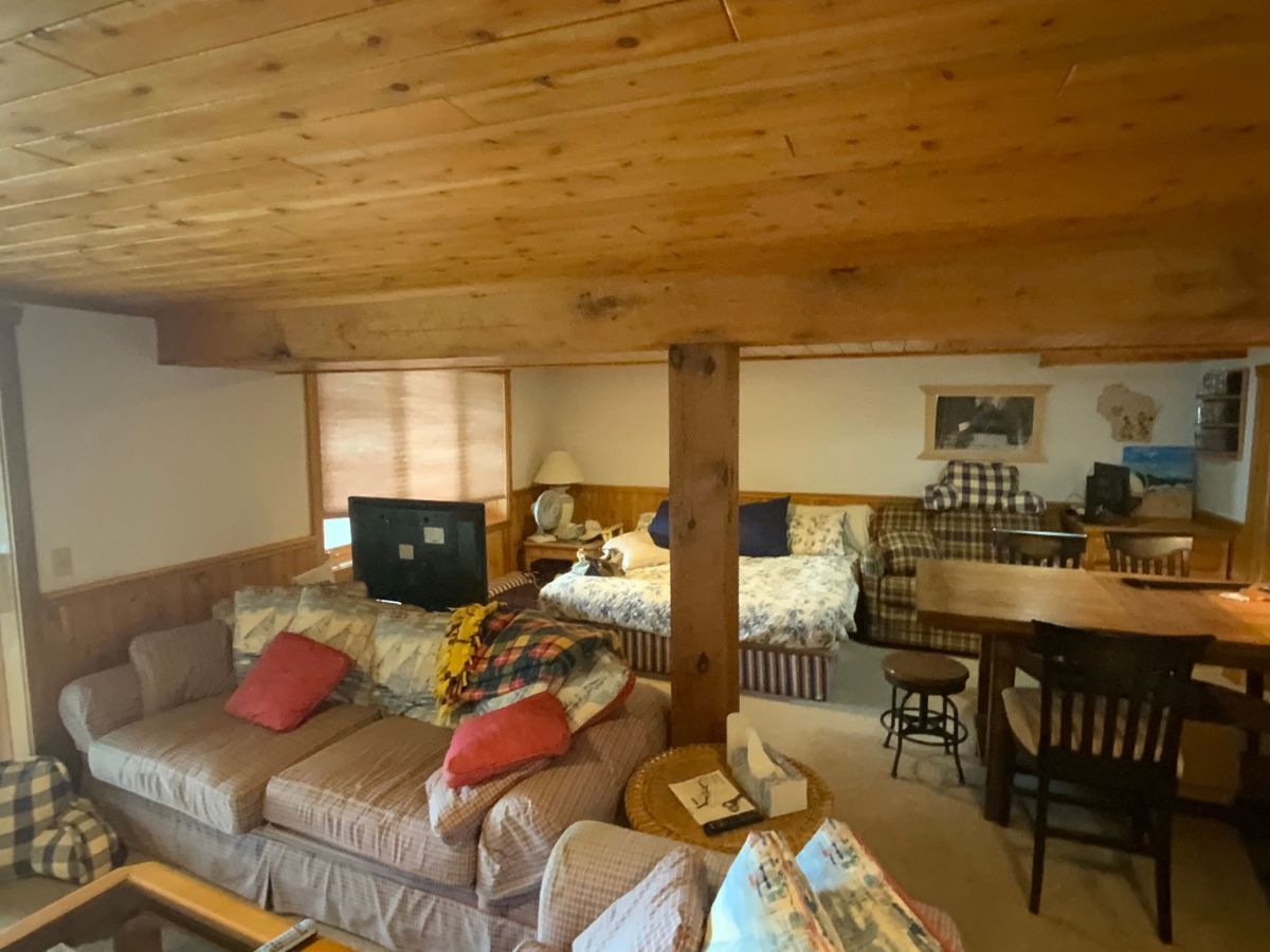 A living room with a couch , table and chairs