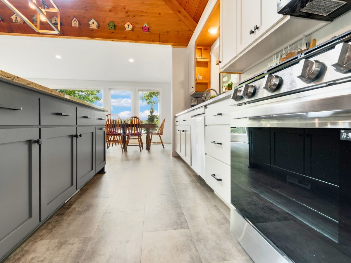 A kitchen with stainless steel appliances and gray cabinets