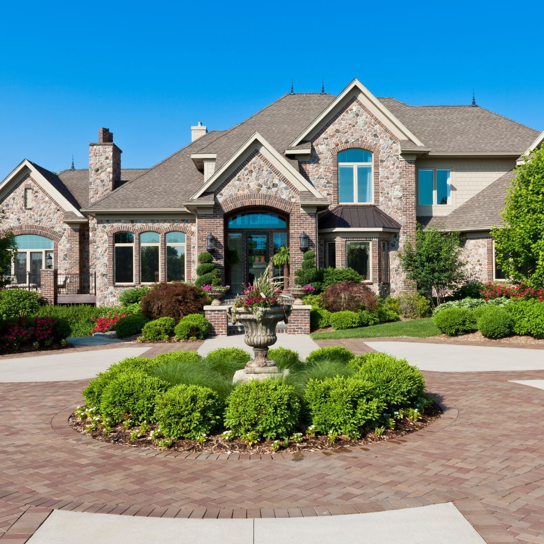 A large house with a fountain in front of it