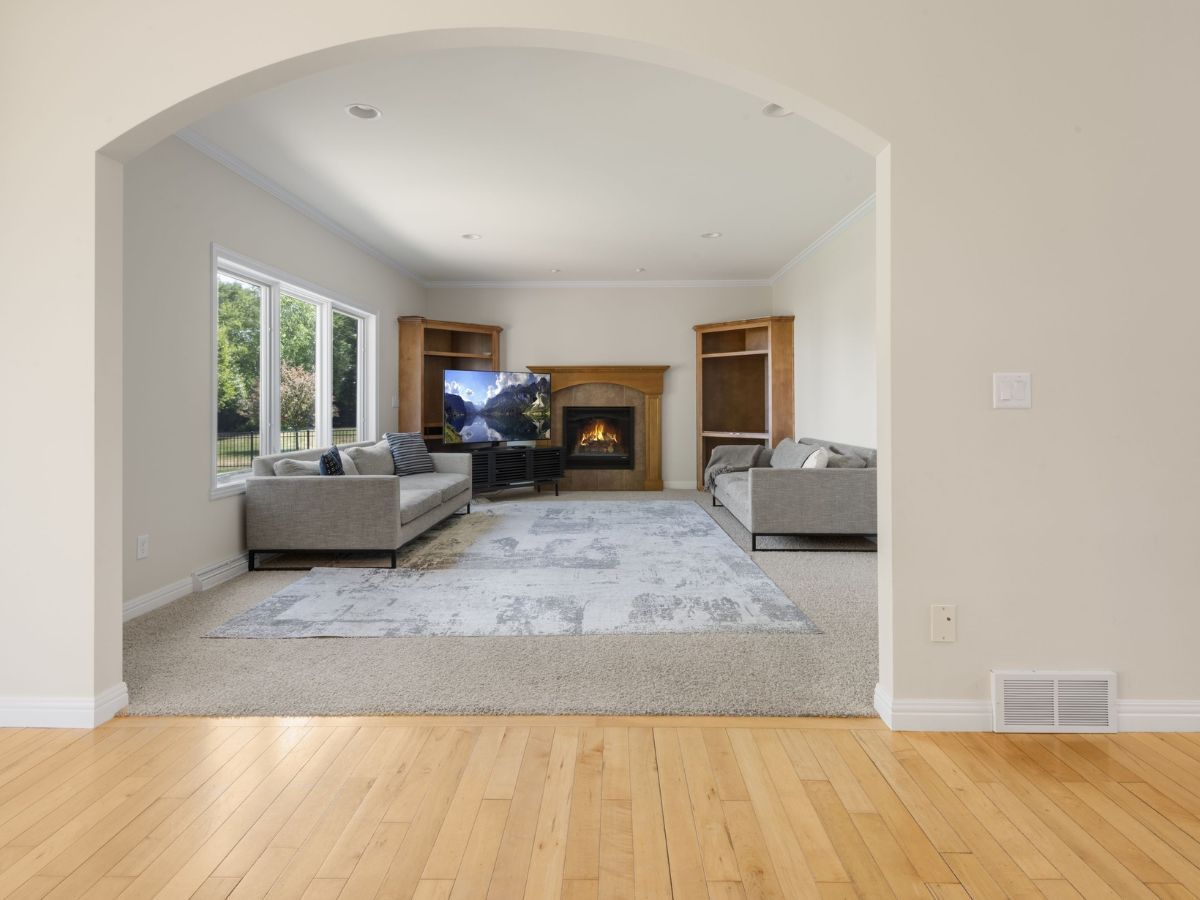 A living room with a fireplace , couch , and television.