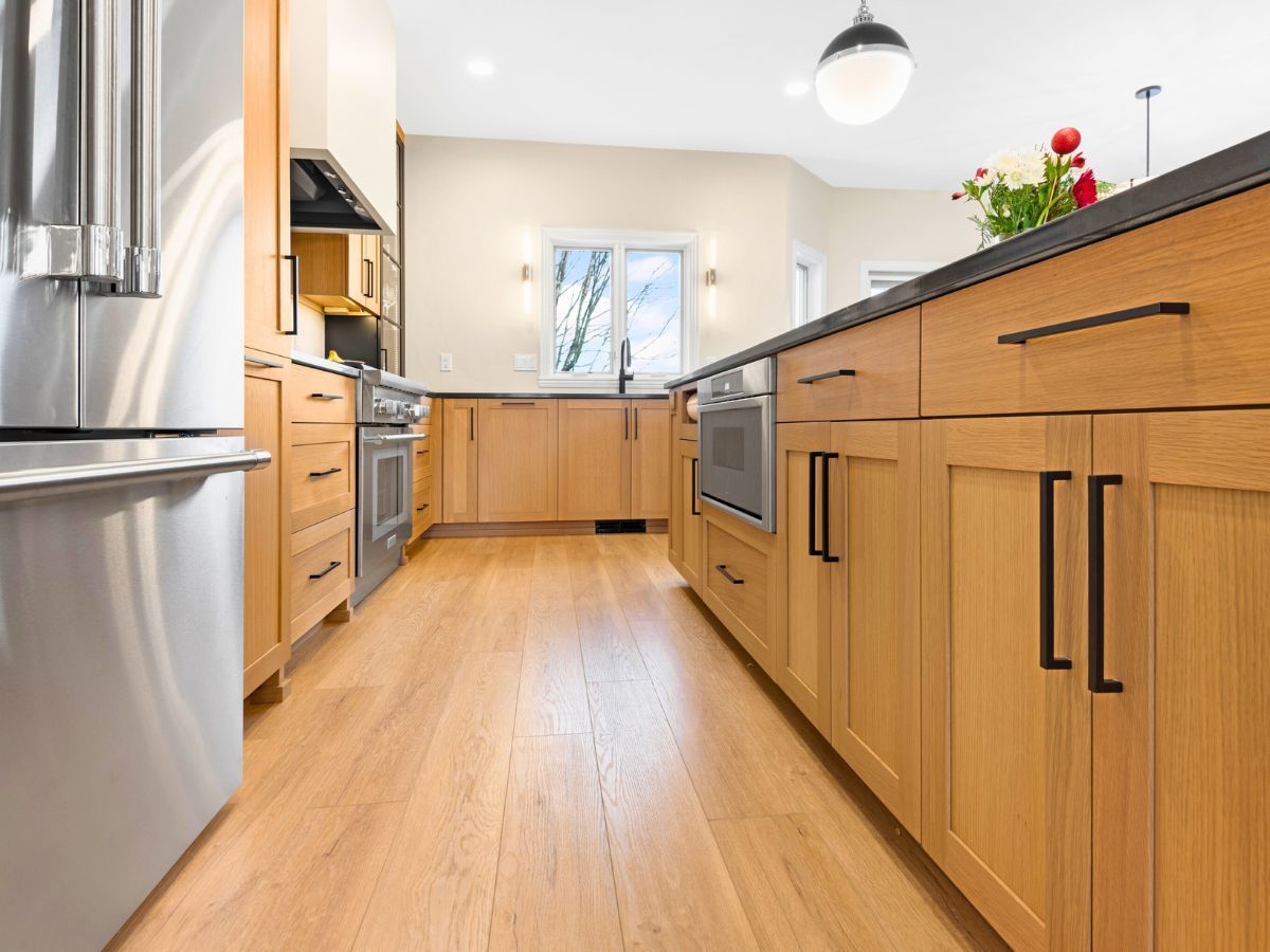 A kitchen with wooden cabinets and stainless steel appliances.