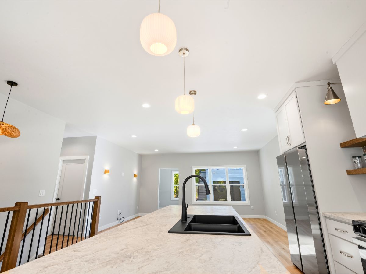 A kitchen with a sink and stainless steel appliances