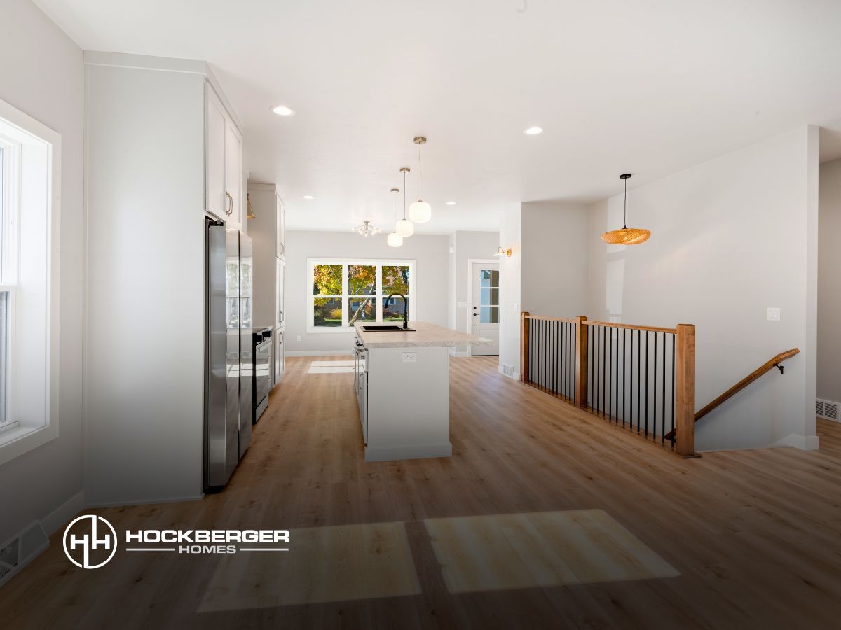 A kitchen with a staircase leading up to the second floor