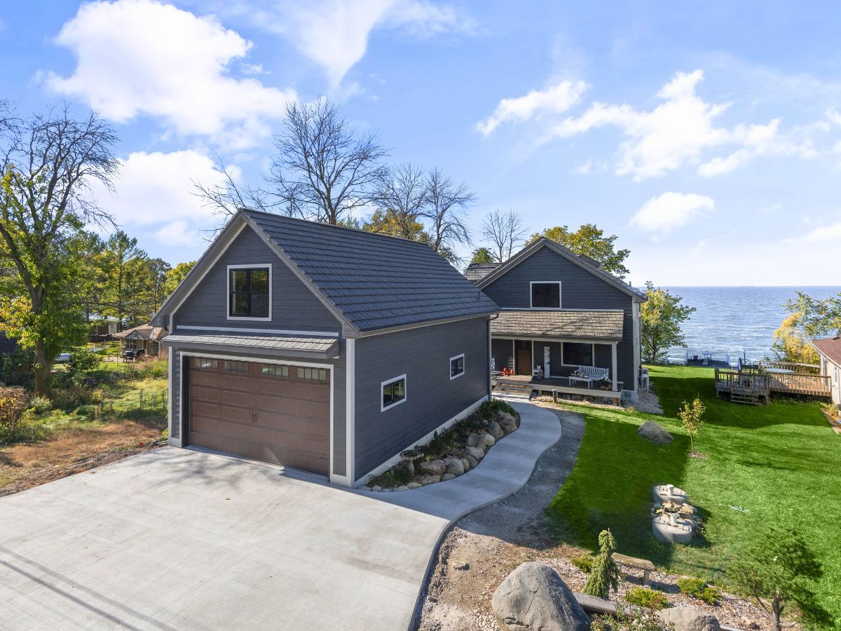 An aerial view of a house with a garage next to it.
