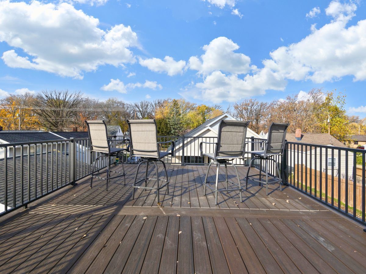 A wooden deck with a table and chairs on it.