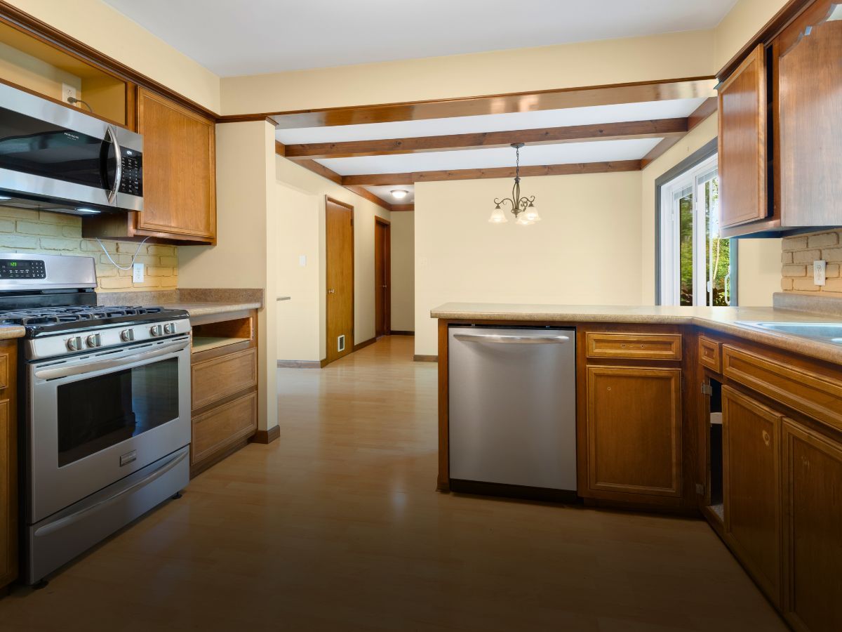 A kitchen with stainless steel appliances and wooden cabinets