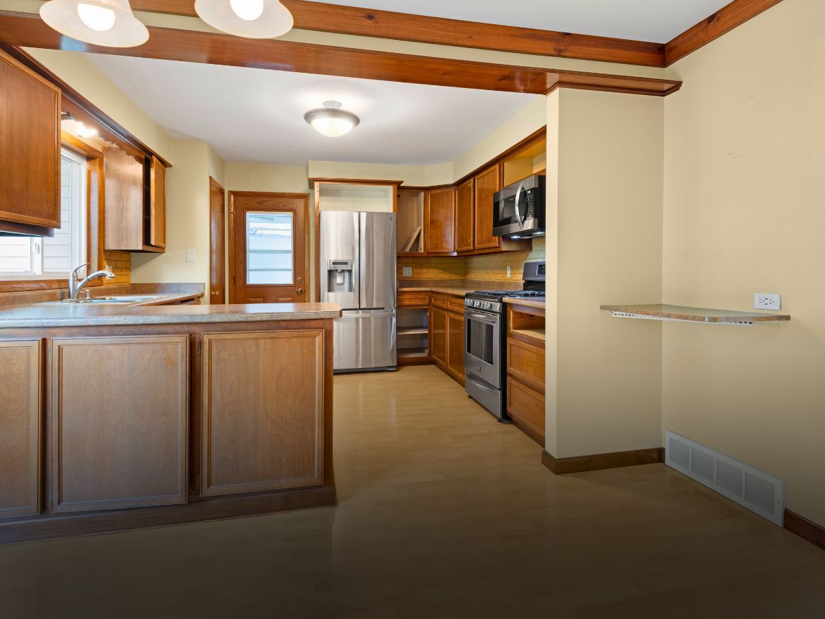A kitchen with stainless steel appliances and wooden cabinets