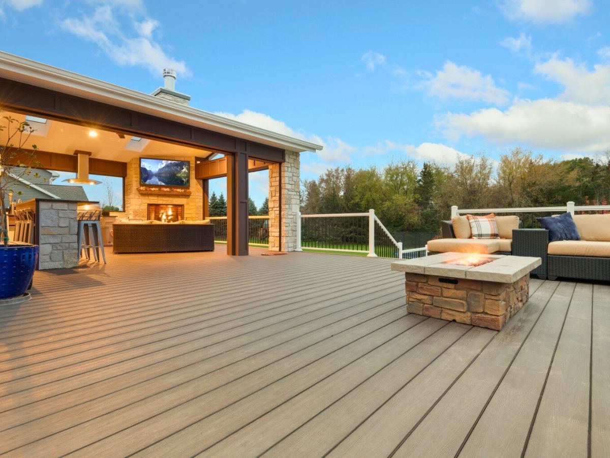 There is a fire pit on the deck of a house.