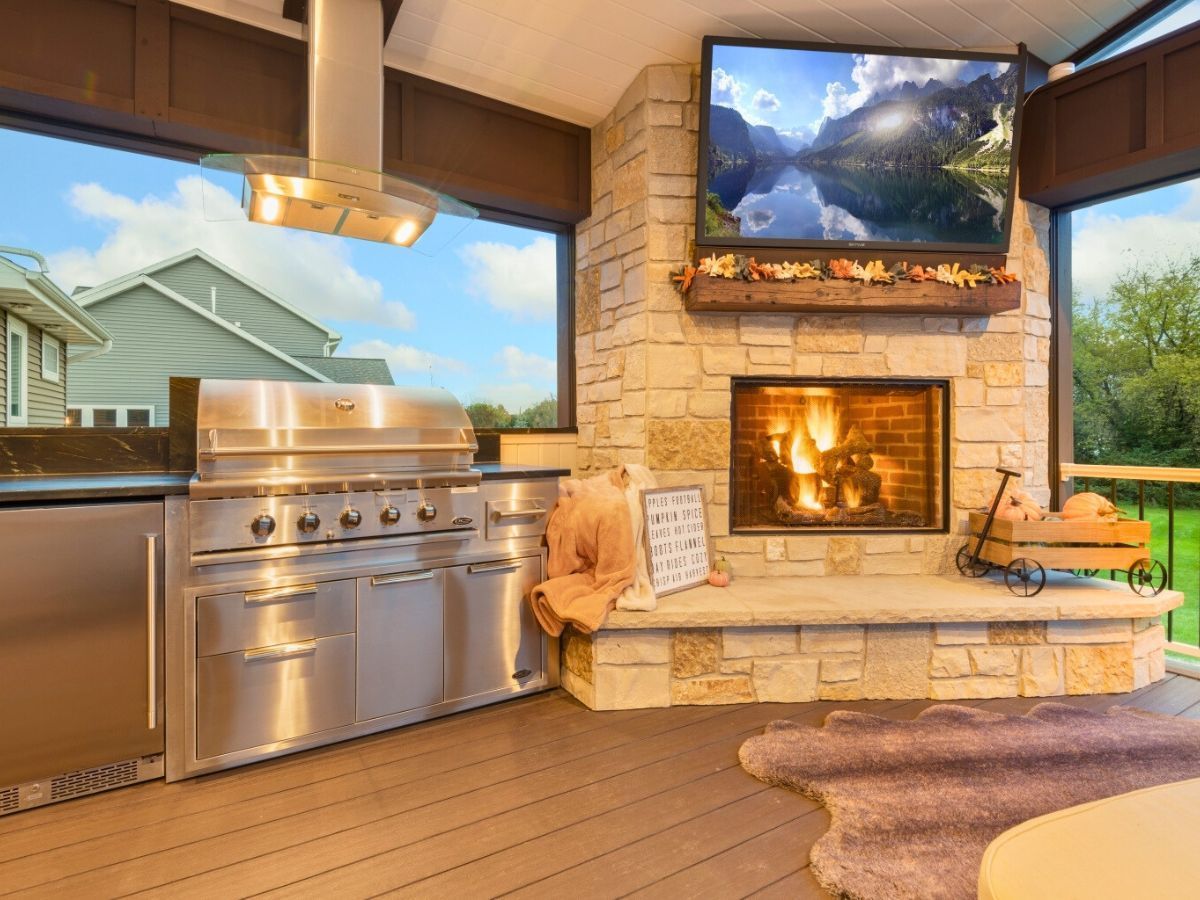There is a fireplace in the middle of the room with a television above it.