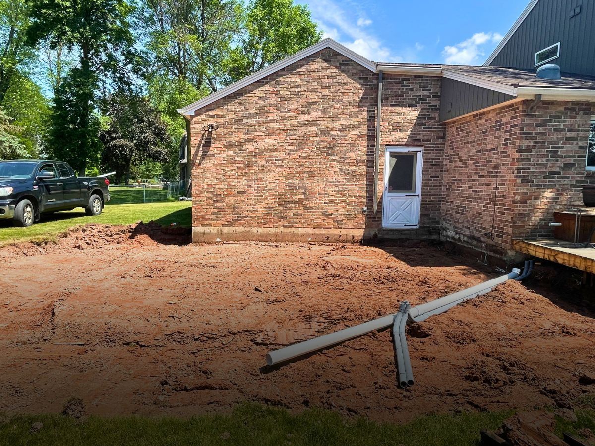 A truck is parked in front of a brick house.