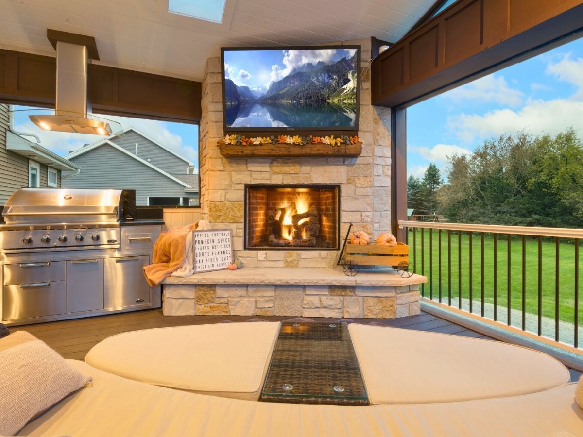 A living room with a fireplace and a flat screen tv.
