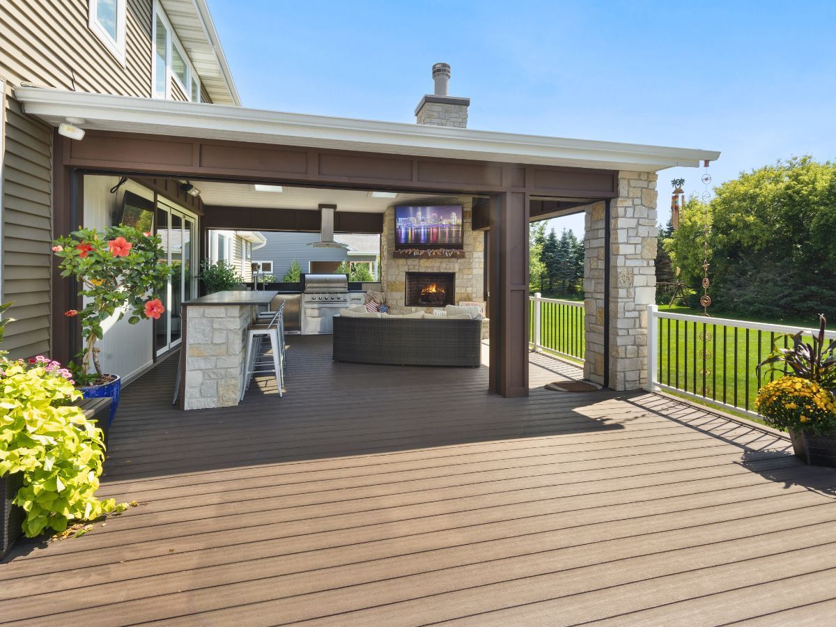 There is a large deck with a fireplace and a television on it.