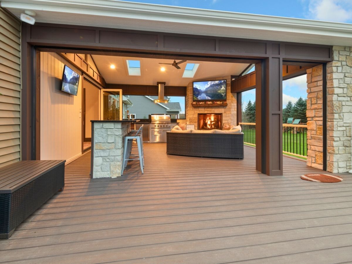 There is a large deck with a kitchen and a fireplace.