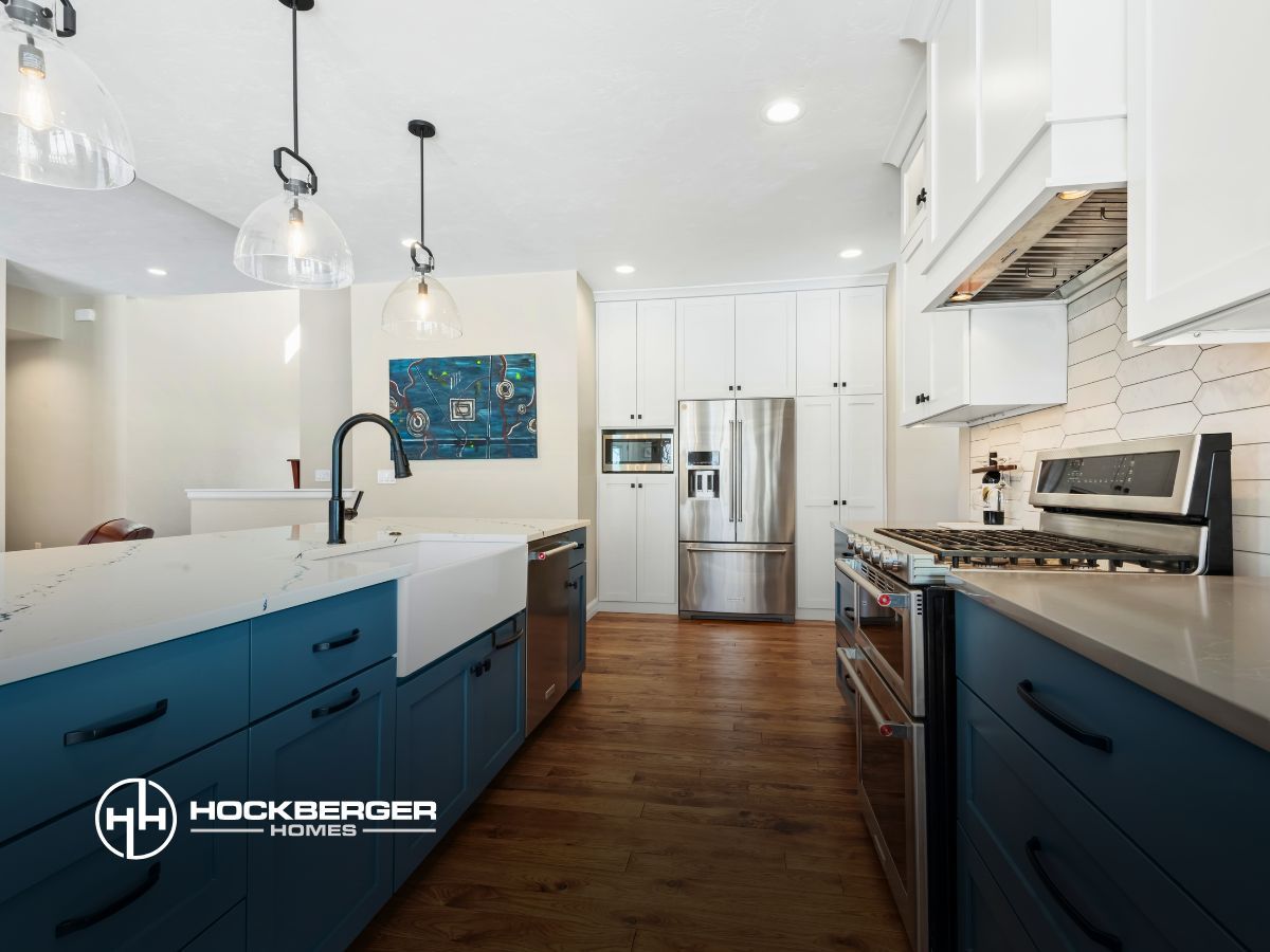 A kitchen with blue cabinets and stainless steel appliances