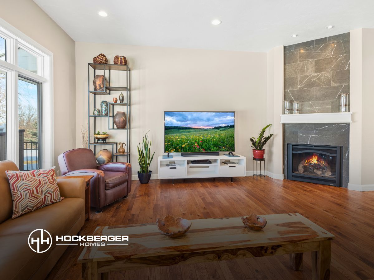 A living room with a fireplace and a flat screen tv.